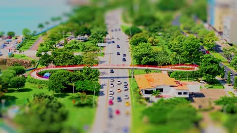 aerial view of a city with a red bridge and lush green parks
