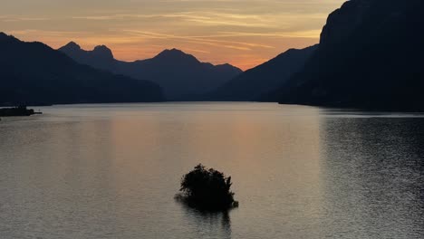 a majestic sunset over lake walensee with the silhouette of the swiss alps in the background