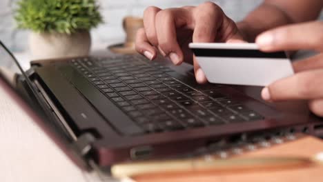 person using a laptop and credit card for online shopping