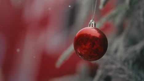 red christmas ornament on a christmas tree