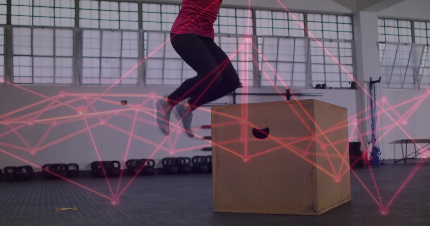 Female athlete building power on plyo box in gym, arm swing initiating takeoff, pink overlay moving