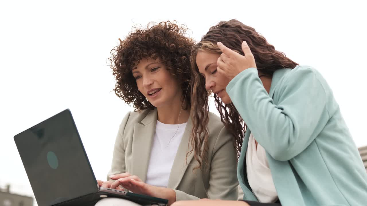 Successful business executives working on netbook outdoors