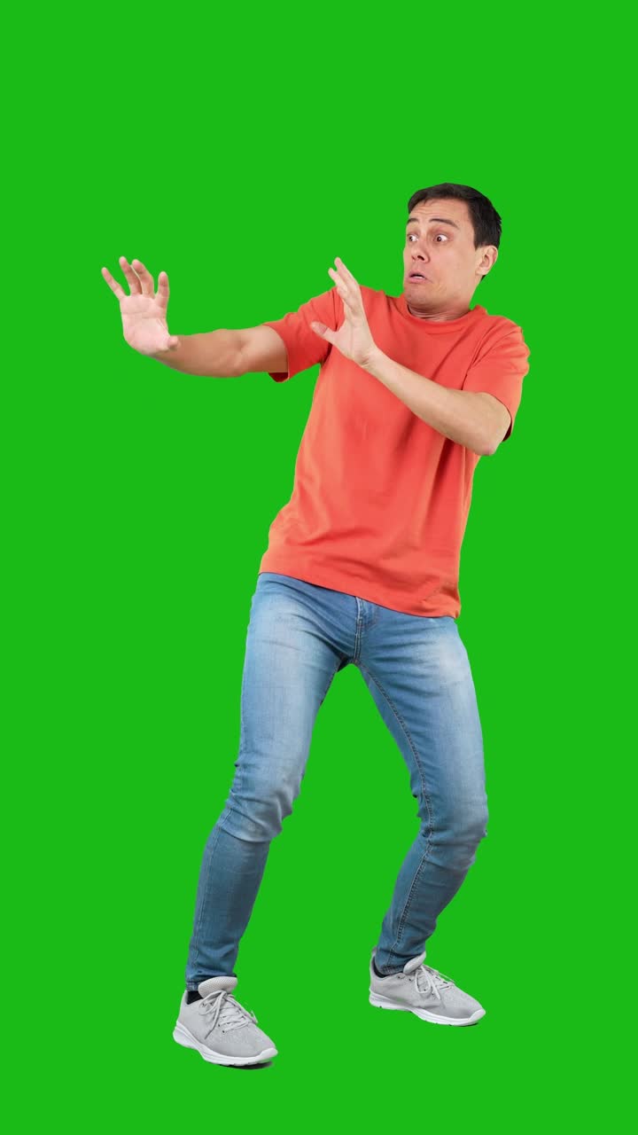 Man showing fear and defense on a green screen