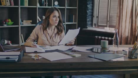 beautiful woman analyzing business documents at office. paperwork