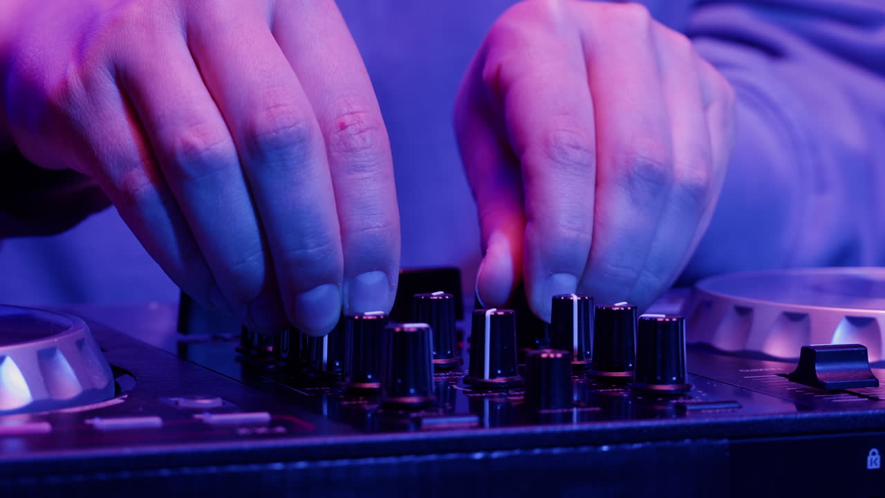 DJ with headphones and sunglasses playing music on festival in night club. Techno musician performing at nightclub for concert crowd of people, city bar.