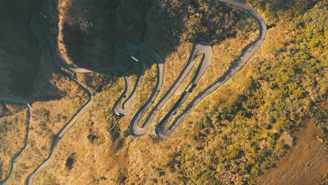 Tropical-rainforest-mountain-dangerous-road-top-down-aerial-cinematic-view,-Serra-Do-Rio-Do-Rastro,-Santa-Catarina-at-sunrise