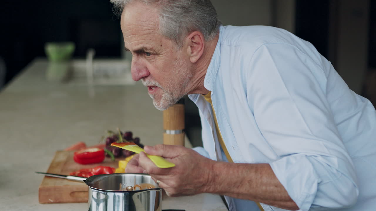 Senior man cooking at home