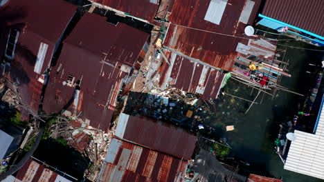 Top-down-vertical-aerial-drone-footage-showing-massive-plastic-pollution-on-a-floating-village-in-Cambodia