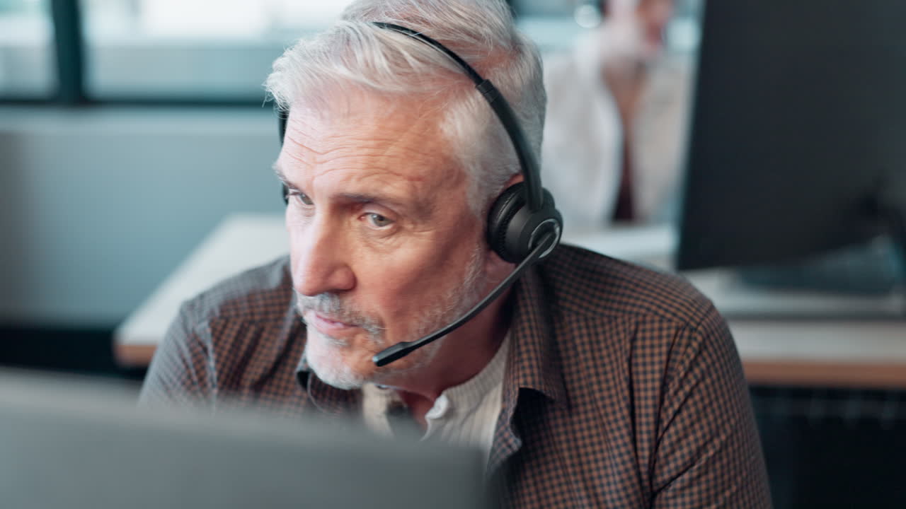 Man with headset working on computer in office