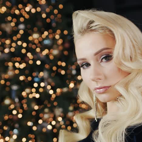 portrait of a young attractive woman against the background of blurred lights of christmas decorations