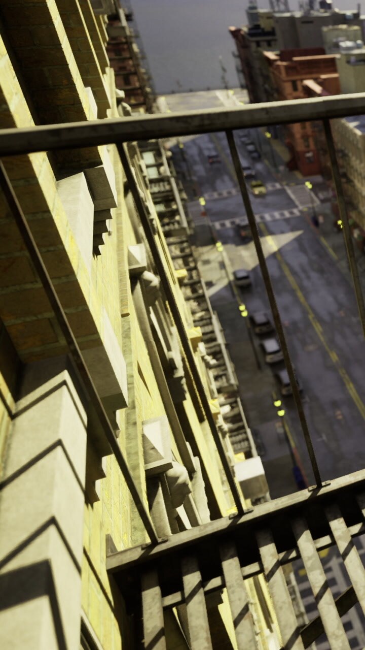 View from a balcony showing city street and buildings below during daytime