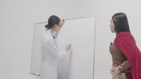 woman wearing profession and superhero costumes for stock content production in indoor studio