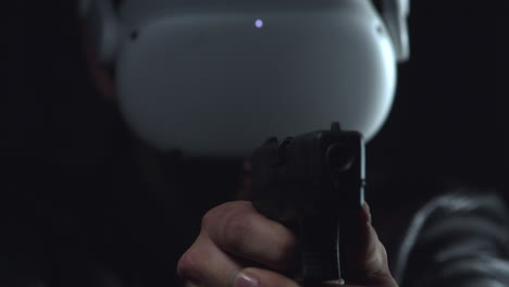 person wearing virtual reality goggles points a gun