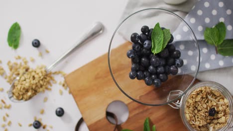 video of cereals and fruit in ceramic bowl on white kitchen worktop