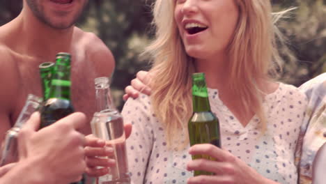 happy friends toasting with beer bottles