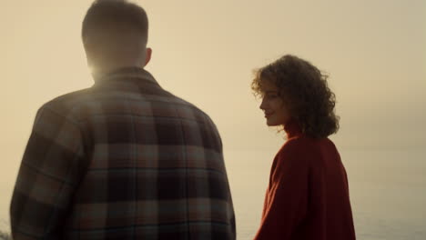 Loving-couple-dating-on-beach-at-sunrise.-Woman-and-man-walking-on-seashore.