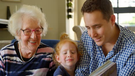 family looking at photo album in living room 4k