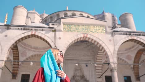 Slow-Motion:-Attractive-beautiful-girl-in-shirt-poses-in-front-of-Sultan-Ahmet-Mosque-in-Istanbul,Turkey