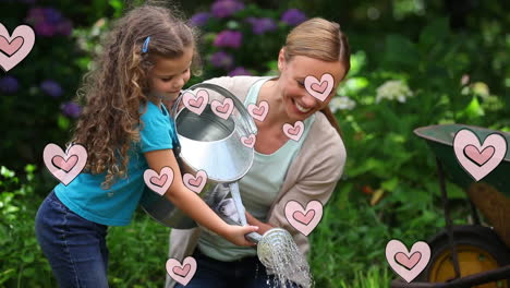 animación de corazones rosados sobre una madre caucásica feliz con su hija sosteniendo una lata de riego