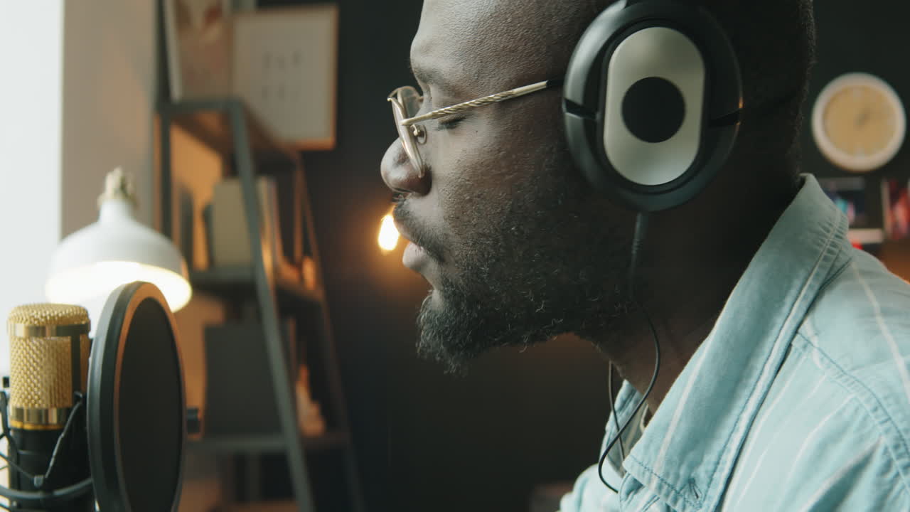Black Man Playing Guitar and Recording Song at Home Studio