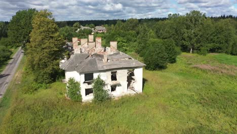 drone video of the roofless abandoned house with old chimneys