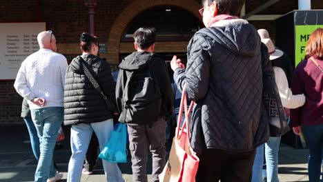 people walking into queen victoria market entrance