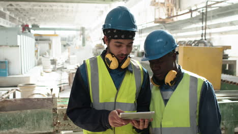 workers looking at tablet