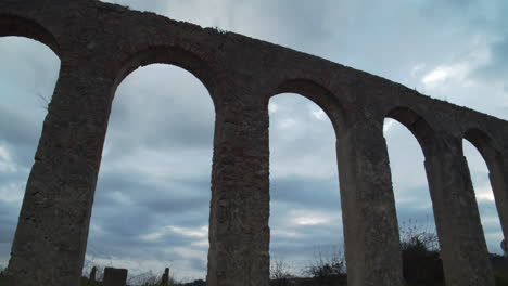 fast passing clouds over the old stone arches