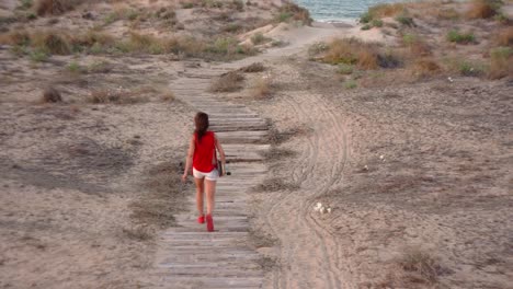 young female skateboarder in the beach