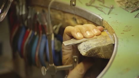 italian goldsmith at work building an engagement or a wedding ring