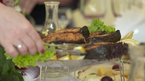 festive dinner table with grilled salmon steaks served on decorative platter