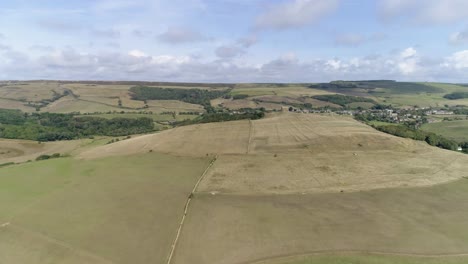 High-aerial-tracking-forward-towards-the-hilltop-and-the-Chapel-of-St-Catherine's-near-Abbotsbury,-Dorset