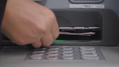 person withdrawing money from atm