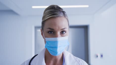 portrait of caucasian female doctor wearing face mask