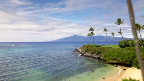 aerial view of golden sand beach and rocky coast on maui island, hawaii