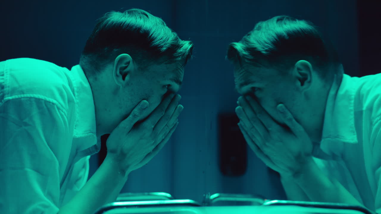 Man Washing Face in a Disturbing Reflection