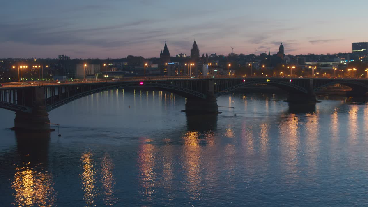 Sunset aerial drone shot of the city of Mainz going over the old bridge showing the Dome in the heart of the city center in best golden hour light with a Drohne