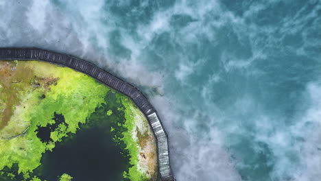 hot smoke from a thermal lake in rotorua, north island, new zealand - aerial top down