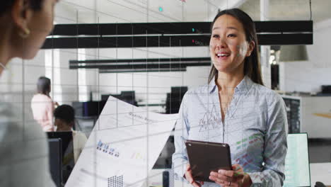 Animation-of-data-processing-over-diverse-female-colleagues-discussing-work-in-office