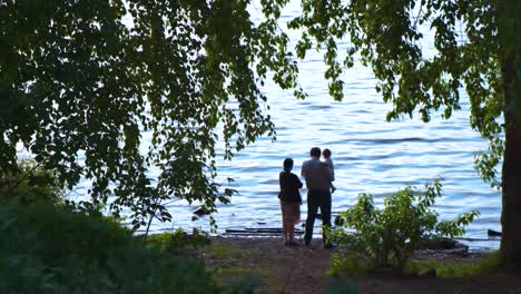 family enjoying the sunset by the lake