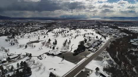 slow pan drone shot over city covered in snow