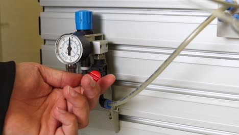 close up shot of a plumber activating a hydraulic pump assembly