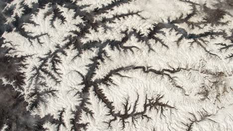flying over the earth on the iss. flying over the snow-capped mountains, aerial view from space.