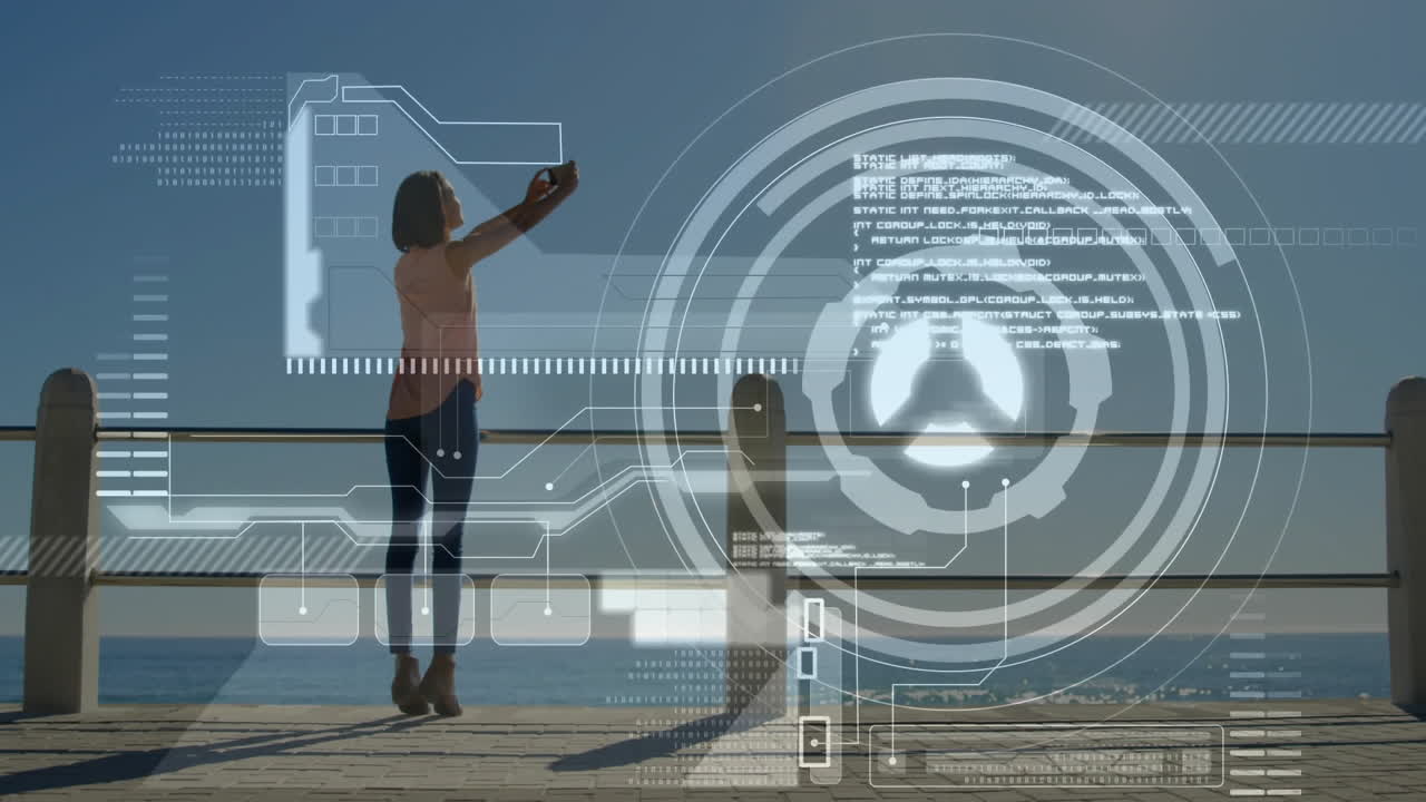 Digital interface animation over person taking selfie by ocean railing