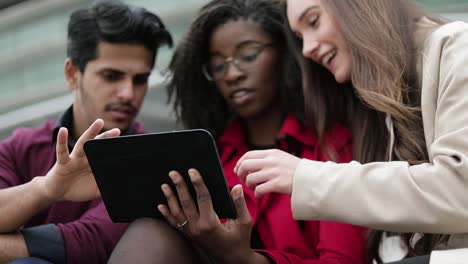 young people googling on tablet place to go, girl explaining