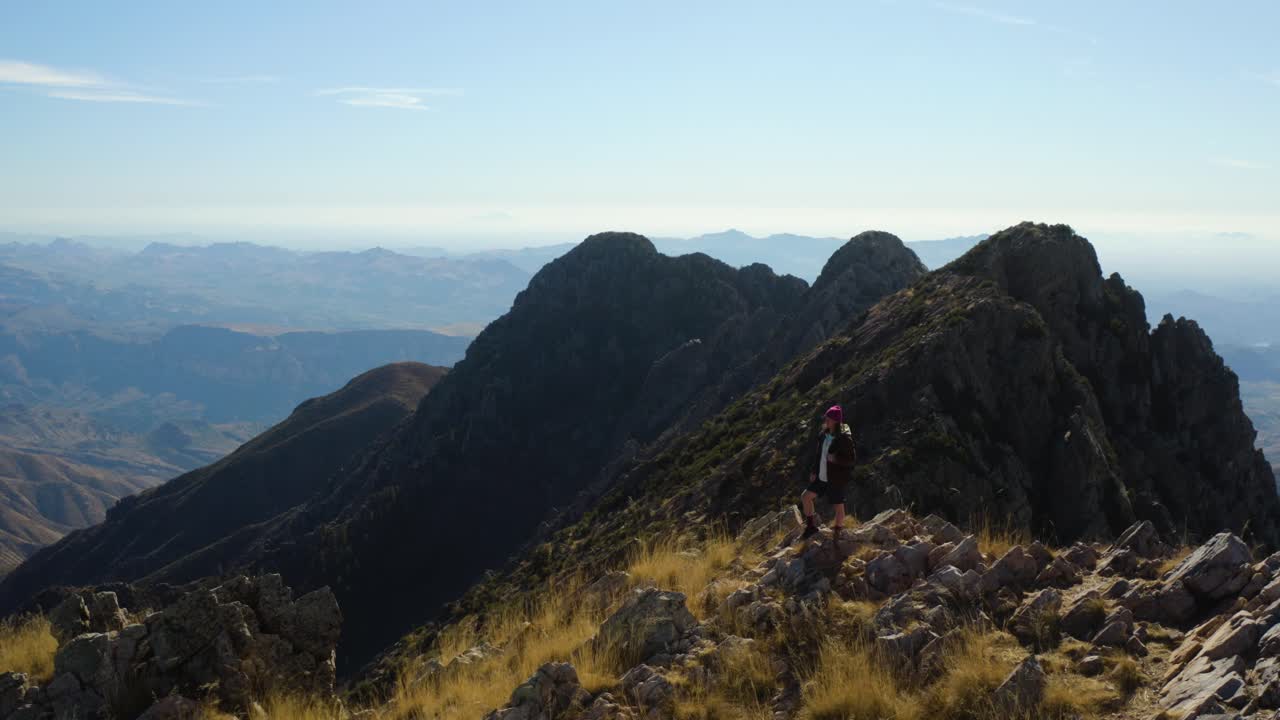 Person celebrating the end of a long hike on top of the Four Peaks mountains, in sunny Arizona - Aerial view