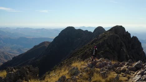 person celebrating the end of a long hike on top of the four peaks mountains, in sunny arizona - aerial view