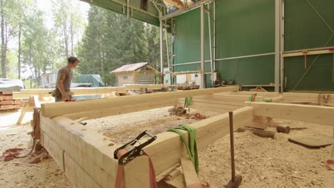 Wide-shot-of-carpenter-working-on-timber-frame-for-his-house-build