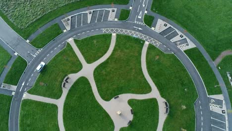 circular design aerial view above ornamental pathway cemetery garden with parking around outside