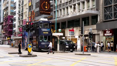 tram and pedestrians at busy hong kong intersection